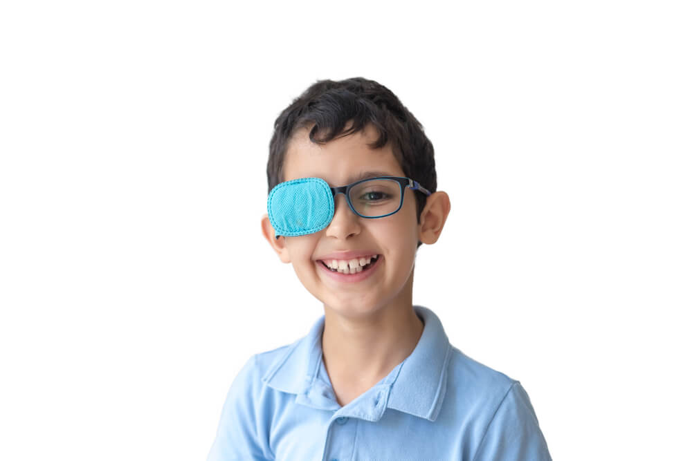 Boy with a patch over his eye to treat amblyopia