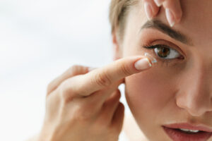 woman applying contact lenses